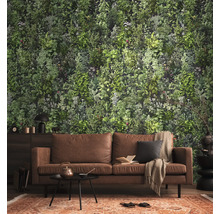 Fotobehang met botanisch plantenpatroon in een woonkamer met een bruine bank en een gedessineerd tapijt.