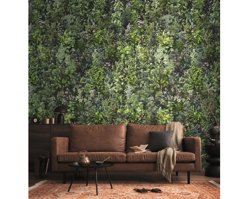 Fotobehang met botanisch plantenpatroon in een woonkamer met een bruine bank en een gedessineerd tapijt.