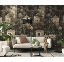Moderne woonkamer met fotobehang van een mediterraan landschap met villa's en palmbomen achter een lichte bank.