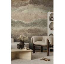Vliesbehang met abstract golvend patroon in berglook in een modern ingerichte woonkamer met fauteuil en lichte salontafel.