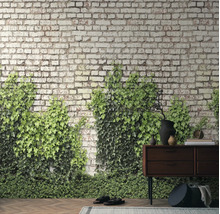Fotobehang met bakstenen look en groene klimop achter een donker houten dressoir op een parketvloer in rustieke stijl.