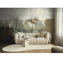Moderne, lichte woonkamer met een bank van structuurstof, ovaal tapijt en fotobehang met een tropisch palmmotief op de achtergrond.