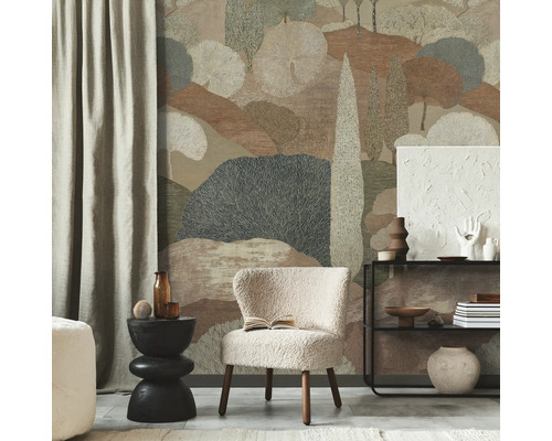 Vliesbehang met gestileerd landschapsmotief in aardetinten in een moderne kamer met beige teddy fauteuil.