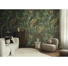 Fotobehang met grote tropische bladeren in jungle-stijl in een modern ingerichte woonkamer met lichte bank en grijze fauteuil.