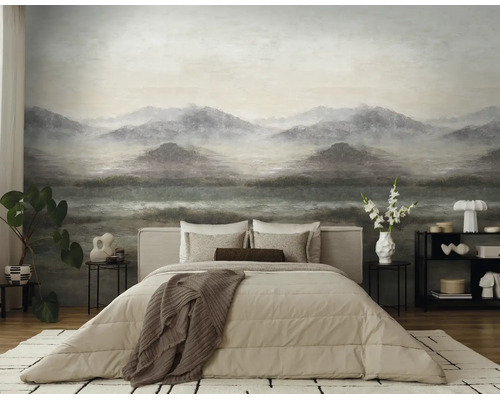 Moderne slaapkamer met een grote fotobehang met een mistig berglandschap. Inclusief tweepersoonsbed met beige beddengoed en een vloerkleed.