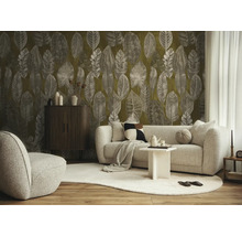 Woonkamer met behang met bladmotief, lichte stoffen bank, donker houten kastje en tapijt op parket.