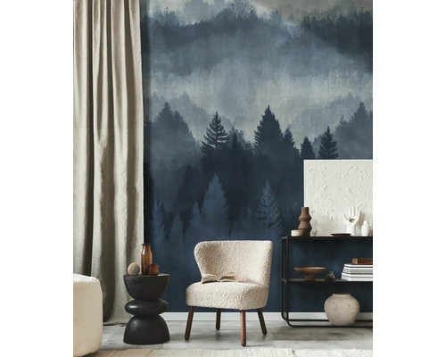 Modern interieur met vliesbehang met mistig bosmotief, een fauteuil met textuur en een metalen rek in een lichte, georganiseerde kamer.