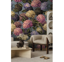 Fotobehang met een grootschalig botanisch hortensia-patroon in een moderne woonkamer met een fauteuil en salontafel.