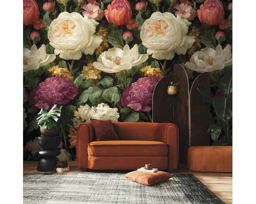 Vlies fotobehang met grote, geschilderde bloemen in een woonkamer met fluwelen bank en planten.