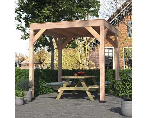 Pergola van licht hout op een grijs stenen terras in de tuin, met een houten picknicktafel eronder.