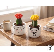 Twee geënte cactussen in witte keramische potten met gezichtsdecoratie op een houten tafel naast een kopje koffie en boeken. (Image AI modified or generated)