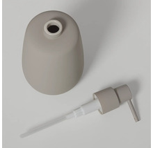 Gedemonteerde zeepdispenser in taupe met mat reservoir en pompje.