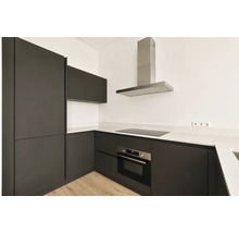 Moderne L-vormige inbouwkeuken met donkere fronten, wit werkblad, inductiekookplaat, ingebouwde oven en afzuigkap.