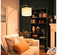 Moderne booglamp met stoffen kap naast een bank in een gezellig ingerichte woonkamer met een donkere kast en een haard. (Image AI modified or generated)