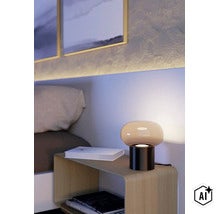 Moderne paddestoellamp op een nachtkastje in de slaapkamer met indirecte verlichting en boeken (Image AI modified or generated)