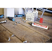 Edding 3300 permanente marker op een werkbank met diverse gereedschappen en metalen onderdelen