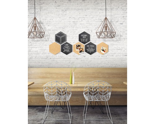 Decoratieve zeshoekige schoolborden en kurkborden aan een bakstenen muur in een restaurant