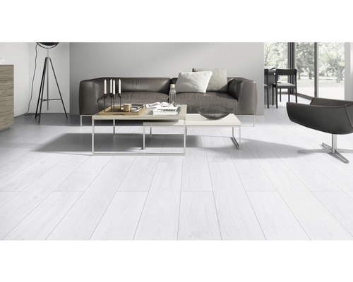 Woonkamer met lichte houten vloer, bank, tafel en stoel