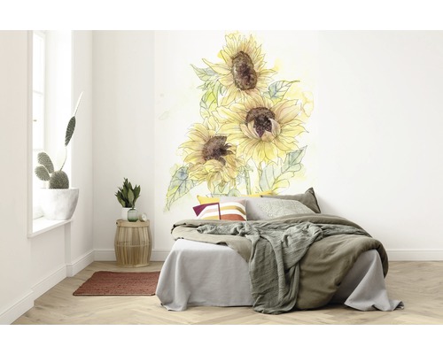 Slaapkamer met muursticker van zonnebloemen boven het bed