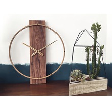 Decoratieve scène met een houten wandklok en een succulenten terrarium.