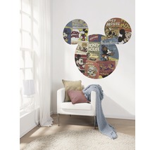 Woonkamer met een fauteuil, een deken en een muursticker in de vorm van Mickey Mouse