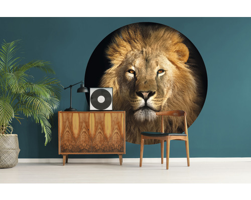 Woonkamer met muursticker van een leeuwenkop, commode, lamp, kamerplant en stoel