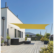 Geel zonnescherm op een terras met tuinmeubilair