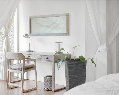 Lichte kamer met bureau, stoel, kamerplant en decoratieve afbeelding