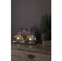 Kerstmarktdorp met verlichting en decoratieve huizen op een tafel