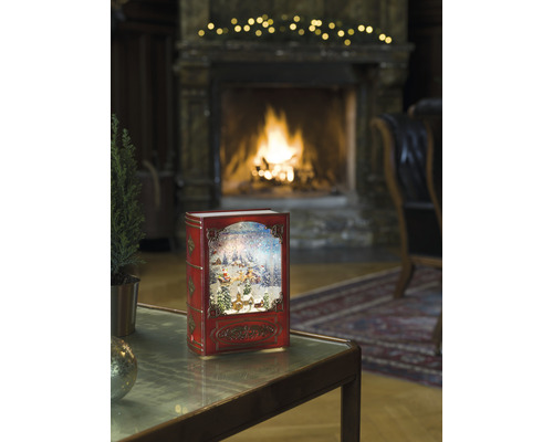 Decoratieve sneeuwbol in boekdesign met kerstmotief voor open haard