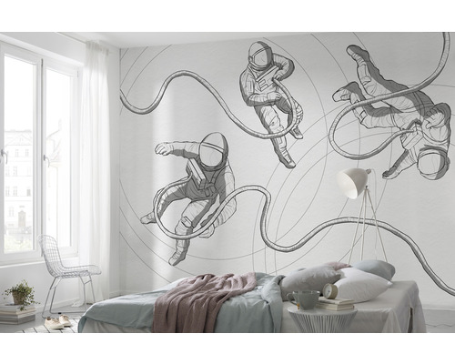 Slaapkamer met fotobehang met astronautenmotief op de muur