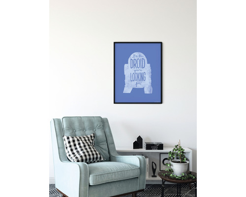 Ingelijste Star Wars wanddecoratie met de tekst Ik ben de droid die je zoekt boven een fauteuil en een plank