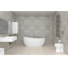 Badkamer met bad, wastafel, toilet, radiator en tegels