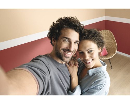 Lachend stel voor muur met kleuraccent