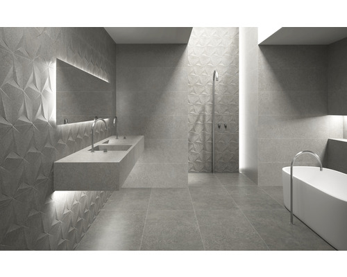 Moderne badkamer met driedimensionale tegels, wastafel en bad.