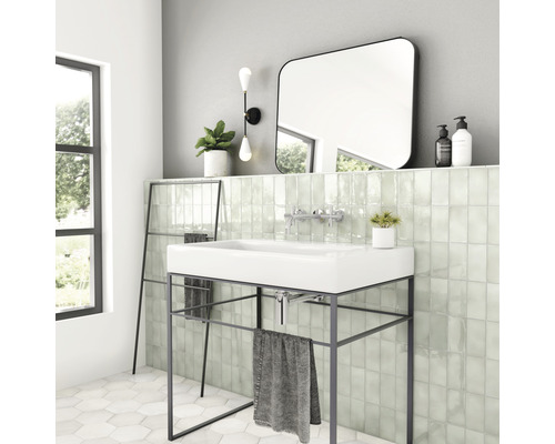 Lichte badkamer met wastafel op metalen frame, spiegel en handdoekenrek