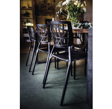 Zwarte stoel met open rugleuning bij een eettafel