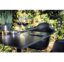 Scene met een gedekte tafel, wijnglazen en decoratie buitenshuis