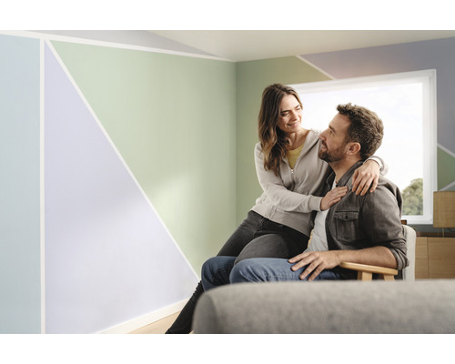 Woonkamer met geometrisch geschilderde muur en stel