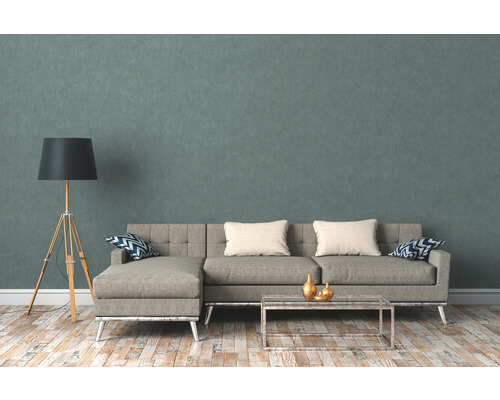 Woonkamer met hoekbank, staande lamp en salontafel