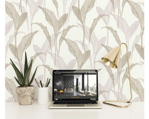 Scene met vliesbehang met bladerpatroon, laptop, bureaulamp en plant in pot