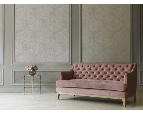 Woonkamer met wandpanelen, patroonbehang, gecapitonneerde bank en bijzettafel met bloemen