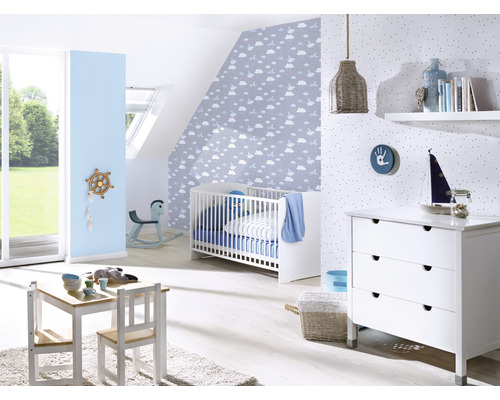 Lichte kinderkamer met kinderbed, commode, tafelgroep en decoraties