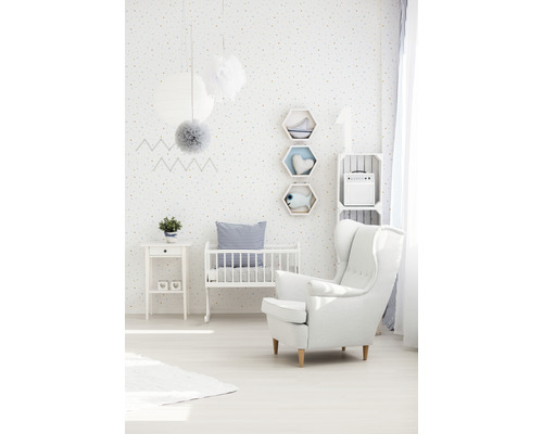 Lichte kinderkamer met kinderbed, fauteuil en decoraties.