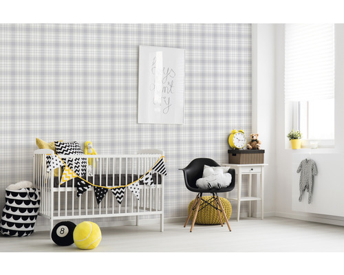 Kinderkamer met geruit behang, kinderbed en decoraties.