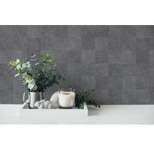 Decoratieve opstelling met een kaars, een plant en grijs behang met linnenstructuur
