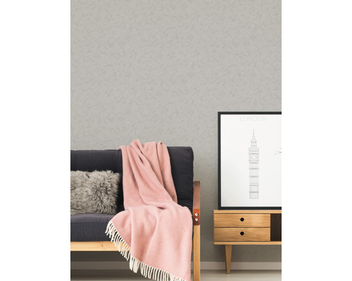 Woonkamer scène met behang, bank, kussen, deken, foto en dressoir