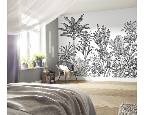 Slaapkamer met jungle behang, bed, stoel en kamerplanten