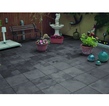 Terras met grijze stenen tegels, tuinbank en decoraties