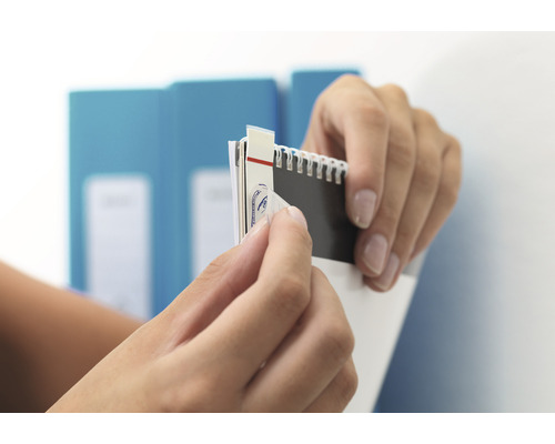 Handen verwijderen een sticker van een notitieboekje.